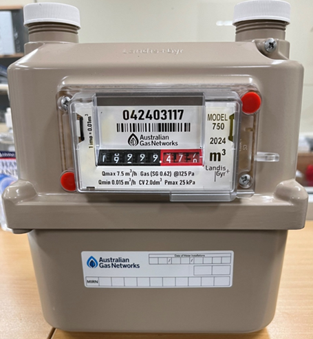 An example of a residential gas meter with numbers on the front which would be the amount of gas usage, and beneath the numbers is an Australian Gas Networks sticker which would contain the meter installation date.